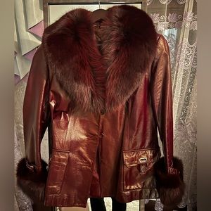 Real leather coat with faux fur trim on both the top and sleeves.